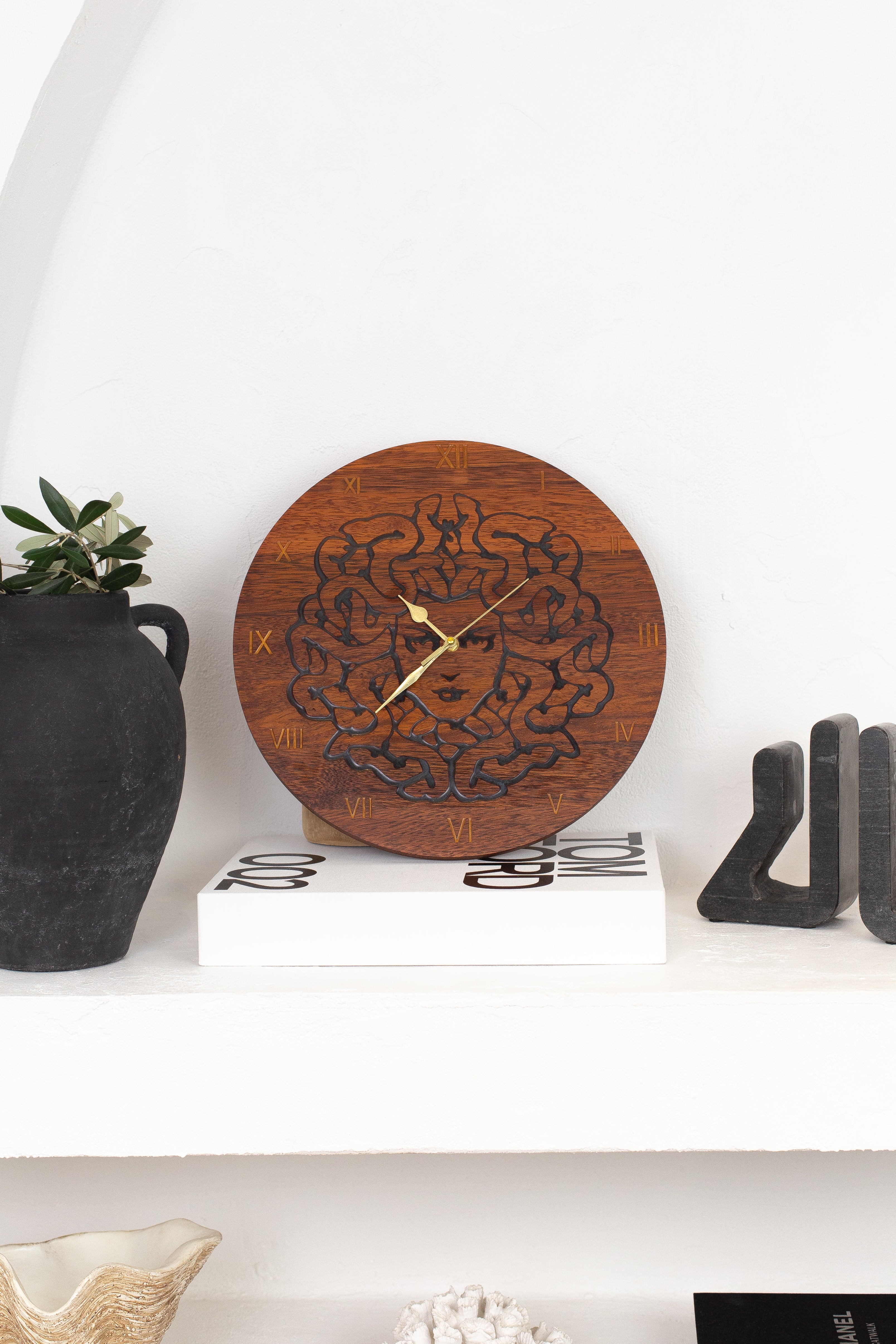 Handcrafted Medusa wall clock design carved in Merbau wood.